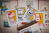 Playing cards featuring cartoon characters on a surface with comic book panels.