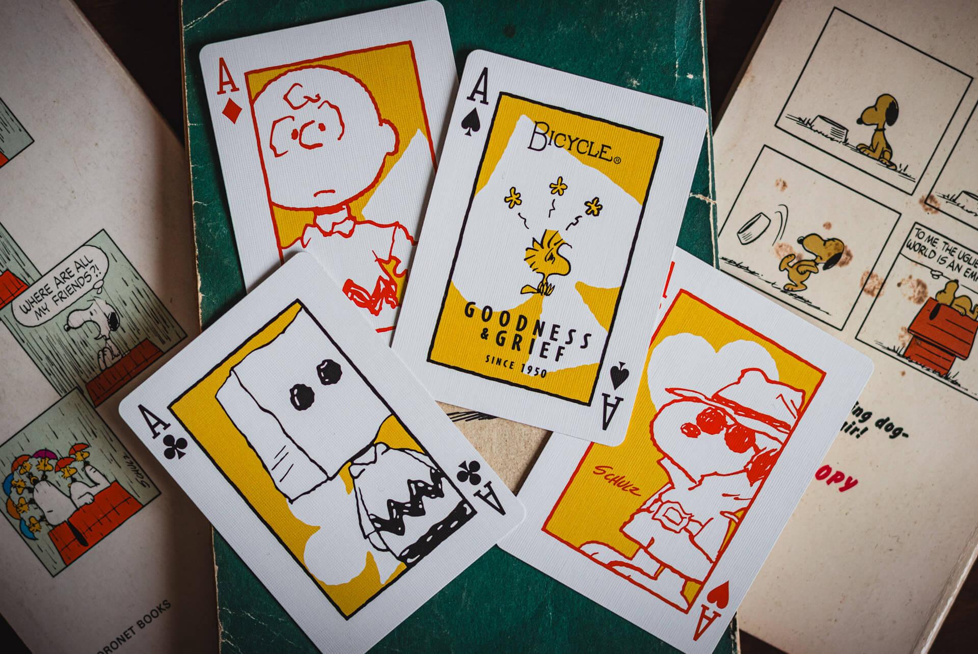 Playing cards with cartoon characters on a green surface