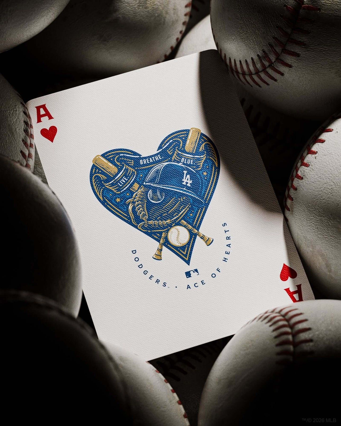 Playing card with Dodgers logo among baseballs