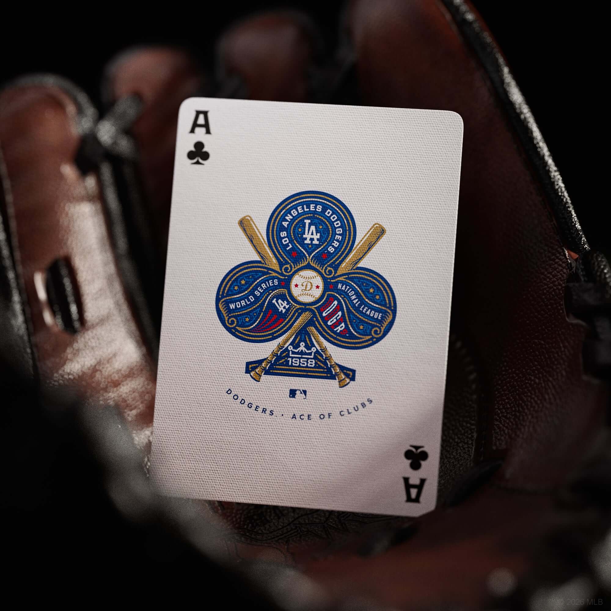 Playing card with Dodgers logo held in a glove